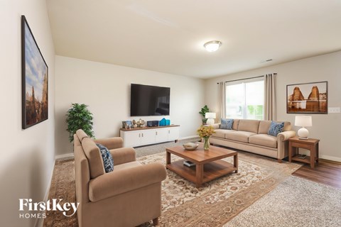A living room with a brown sofa and a coffee table.