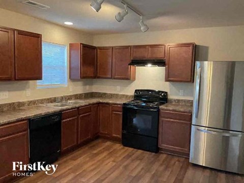 A kitchen with wooden cabinets and stainless steel appliances.
