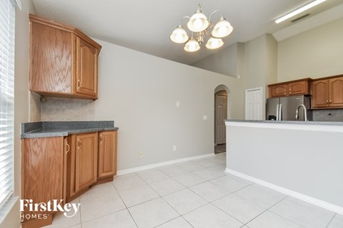 A kitchen with wooden cabinets and a granite countertop.