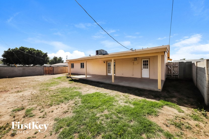 a small house with a yard in front of it