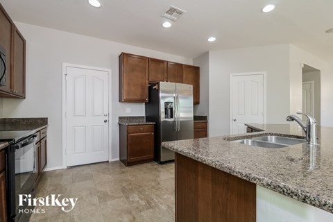 A kitchen with a granite countertop and a sink.
