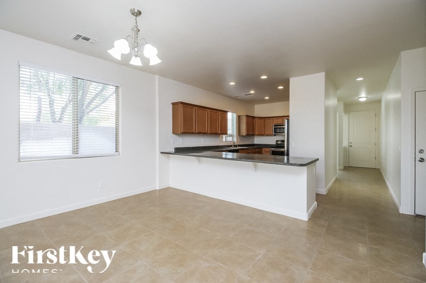 A spacious kitchen with a bar area and a dining area.