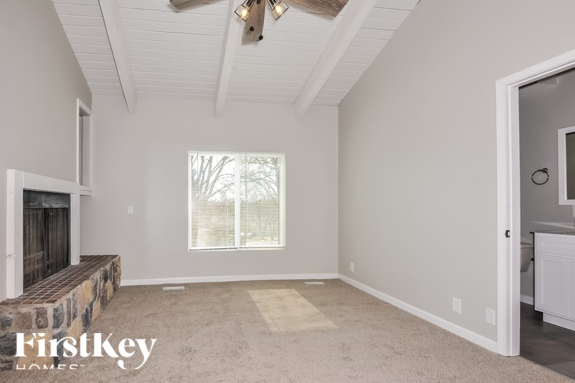 A room with a fireplace and a window.