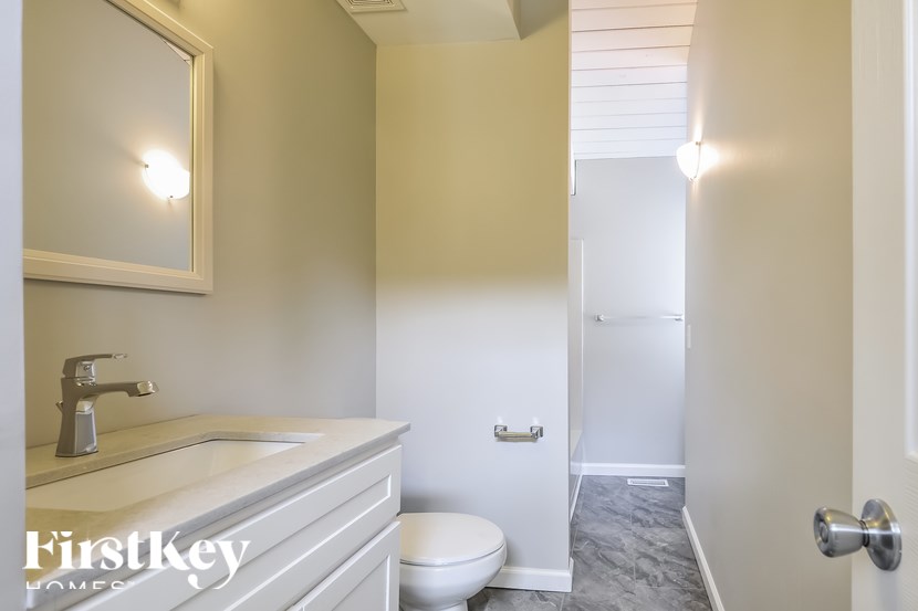 A bathroom with a white toilet and a white sink.