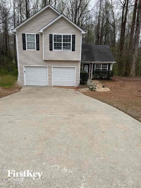 a house with a concrete driveway in front of it