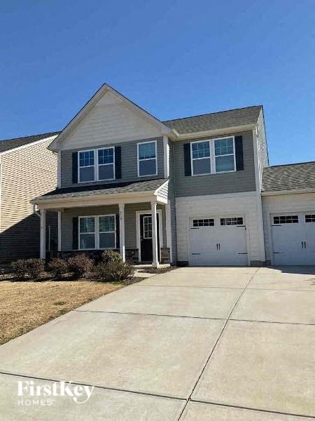 A two-story house with a garage is for sale.