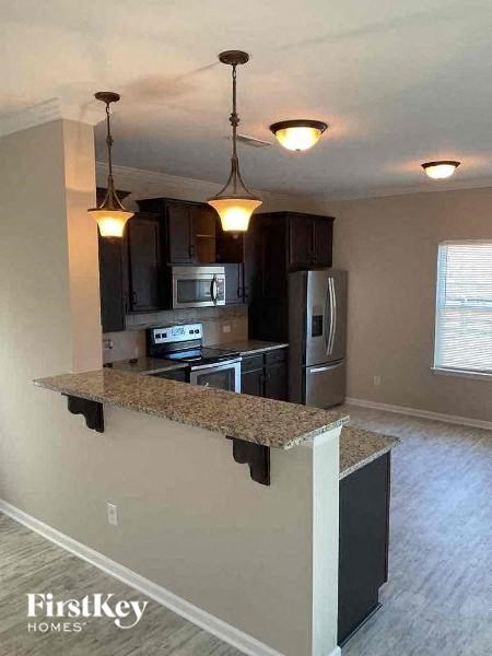 A kitchen with granite countertops and stainless steel appliances.
