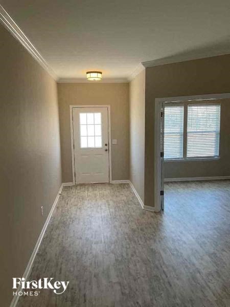 A room with a door and a window with blinds.