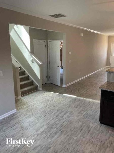 A room with a staircase and a door.