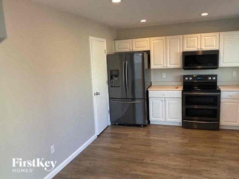 a kitchen with stainless steel appliances and white cabinets