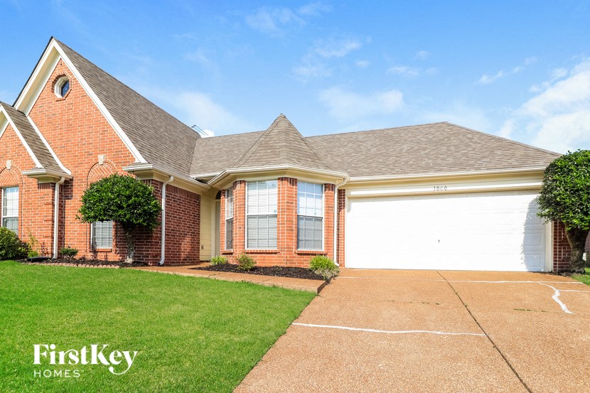 a brick house with a white garage door