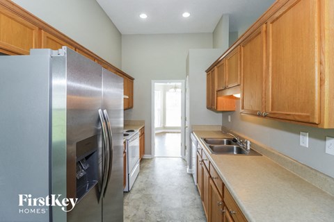 a kitchen with stainless steel appliances and wooden cabinets