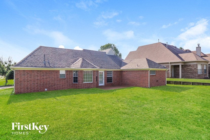 a brick house with a lawn in front of it