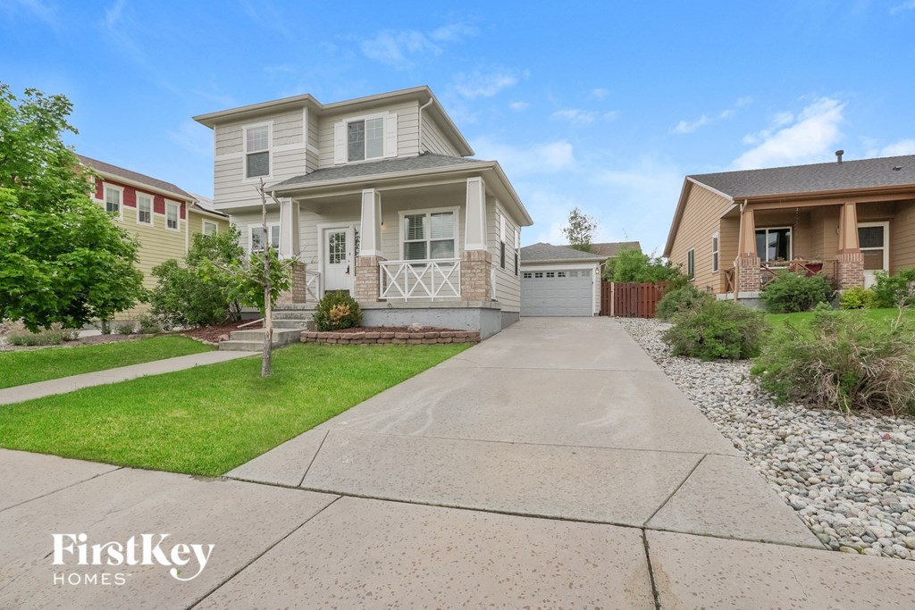 a white house with a driveway in front of it