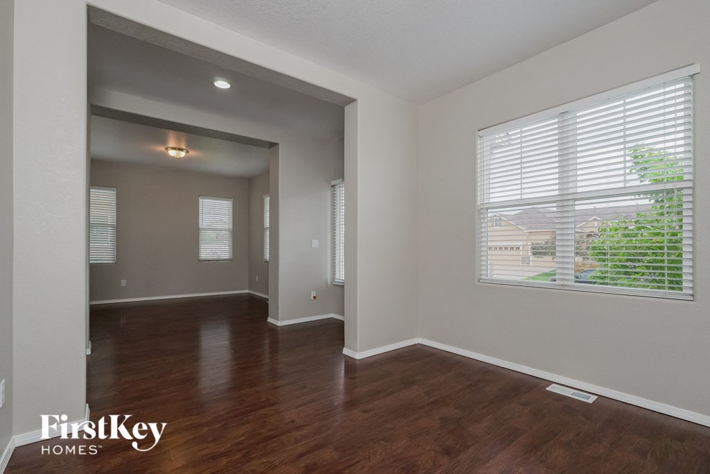 a living room with wood floors and a large window
