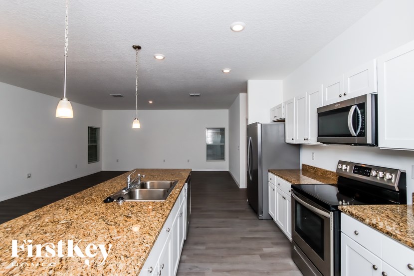 A kitchen with granite countertops and stainless steel appliances.