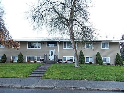 a house with a tree in the front of it