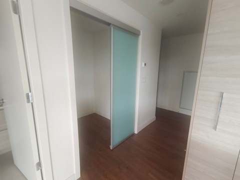 a bedroom with a closet and a hard wood floor