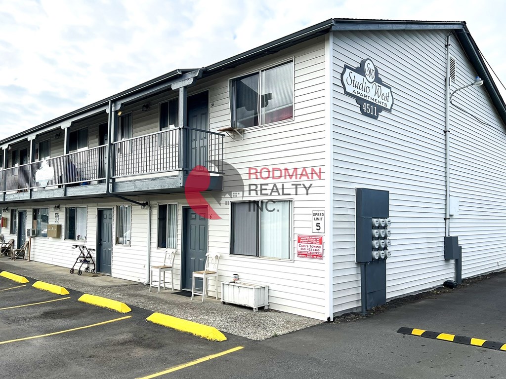 A building with a sign that says Rodman Realty Inc.