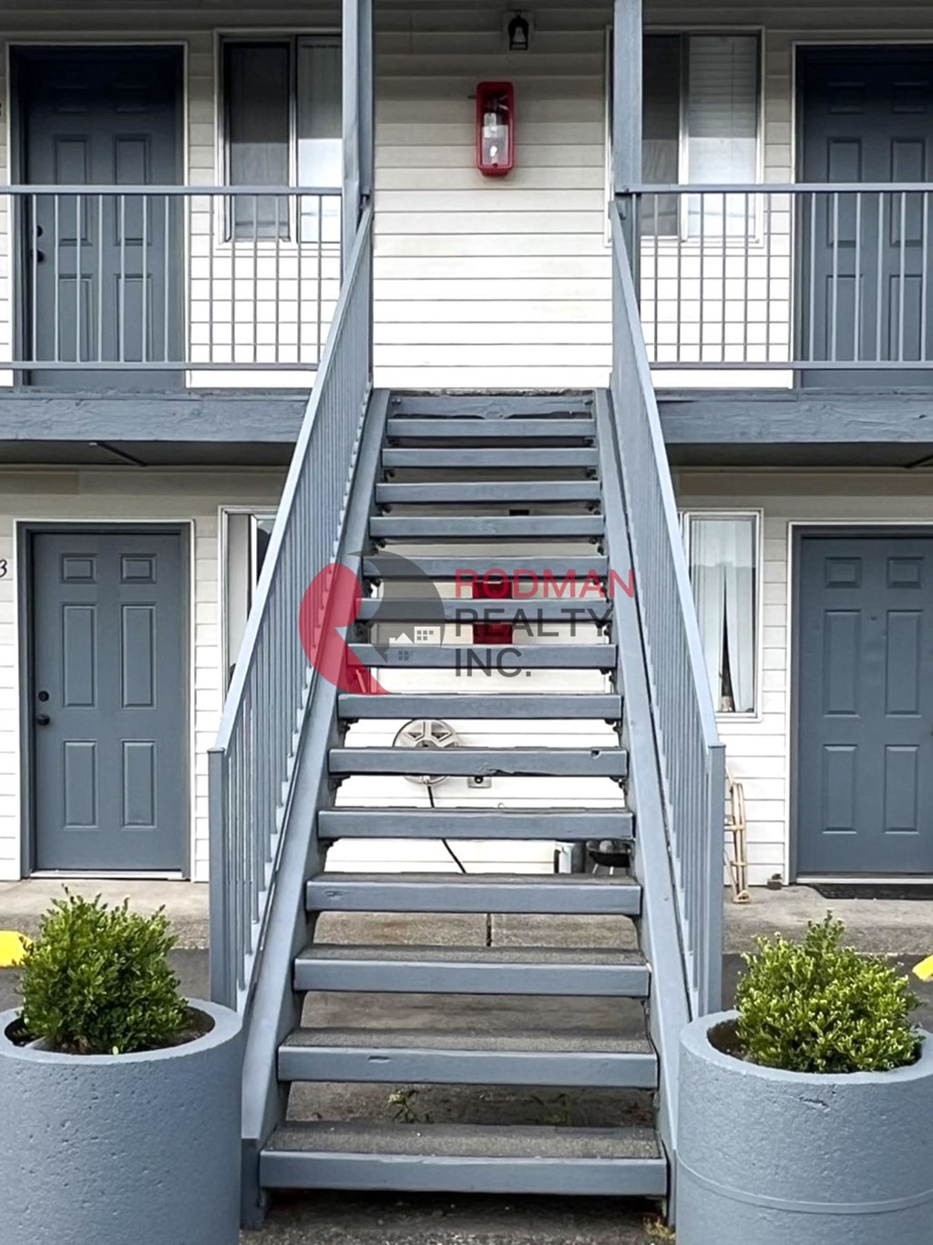 A staircase with a red sign that says "RETAIL SPACE" on it.