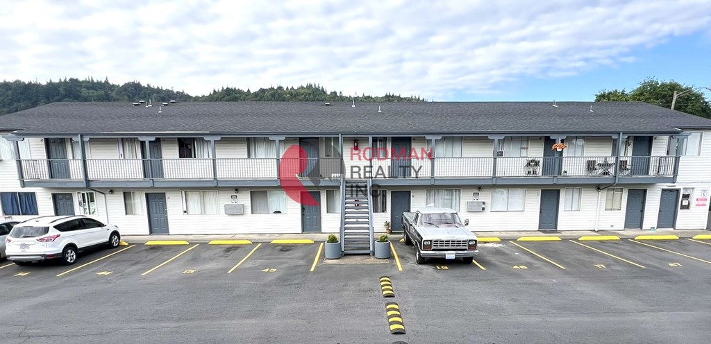 A white building with a red logo on the side.