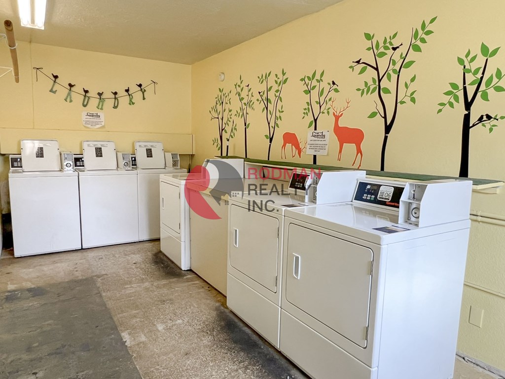 A laundromat with Real Inc. on the wall.