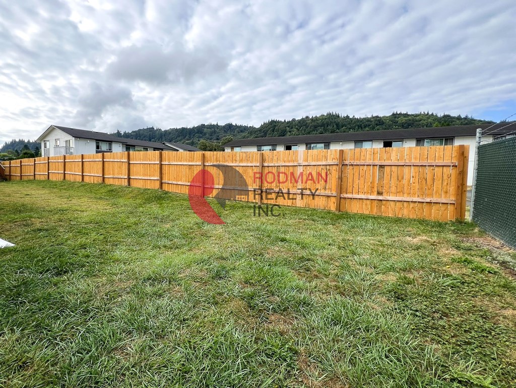 A fence with the text "HODMAN HEALTH" painted on it.
