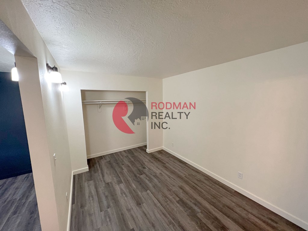 A room with Rodman Realty Inc. written on the wall.