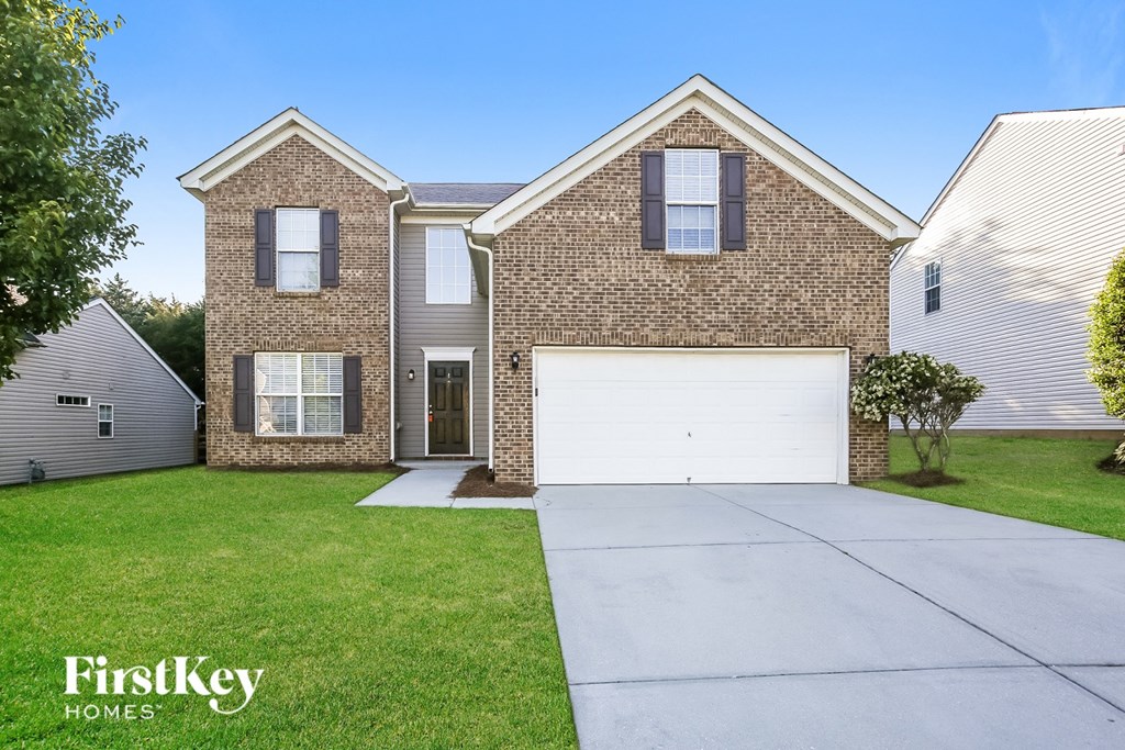 A brick house with a garage is for sale by FirstKey Homes.