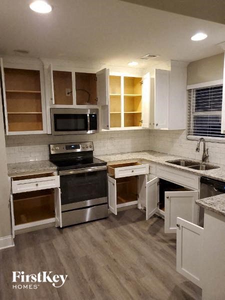 a kitchen with stainless steel appliances and white cabinets