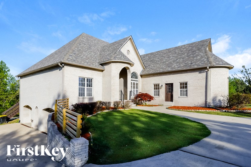 A large house with a white exterior and a grey roof.