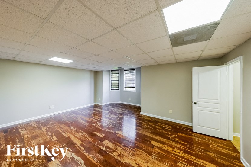 A room with wooden flooring and a skylight.