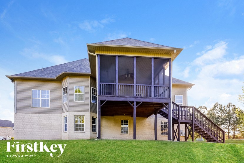 A two-story house with a balcony on the upper floor.