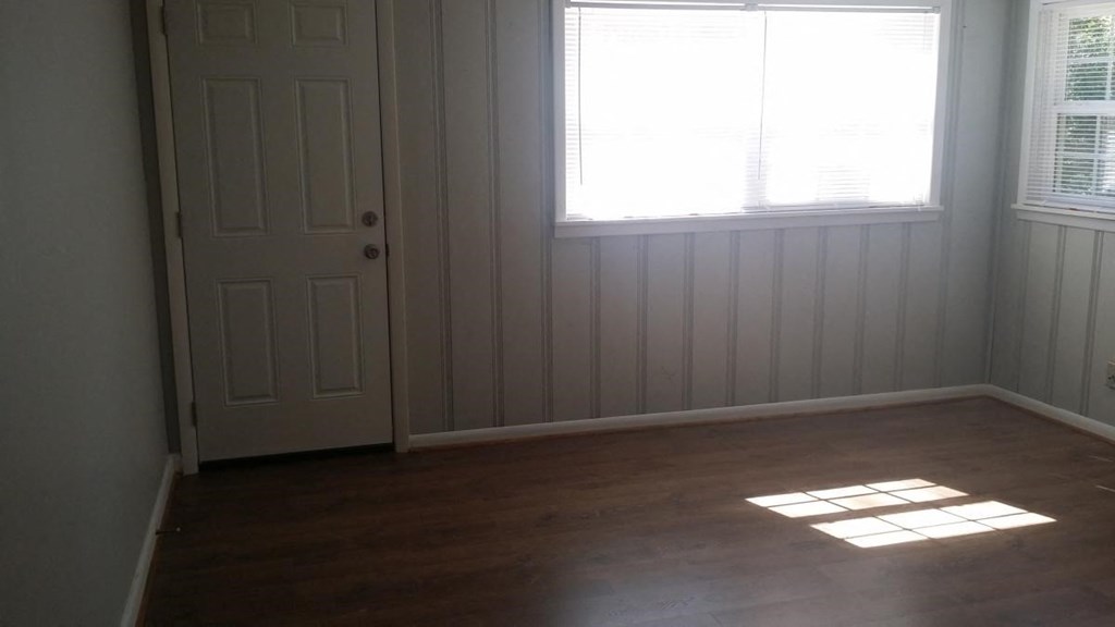 an empty room with a door and a window