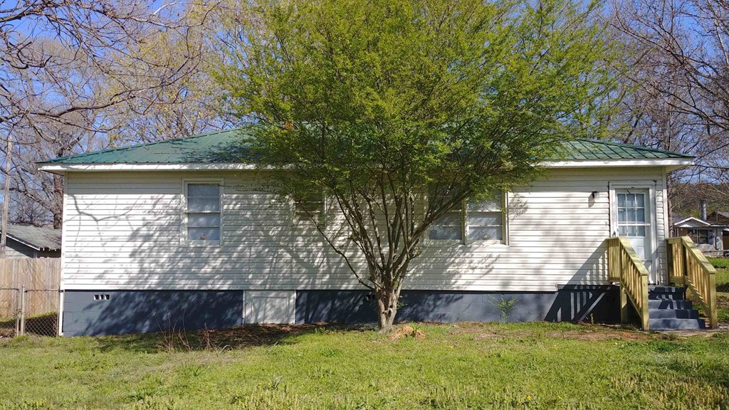 a white house with a tree in front of it