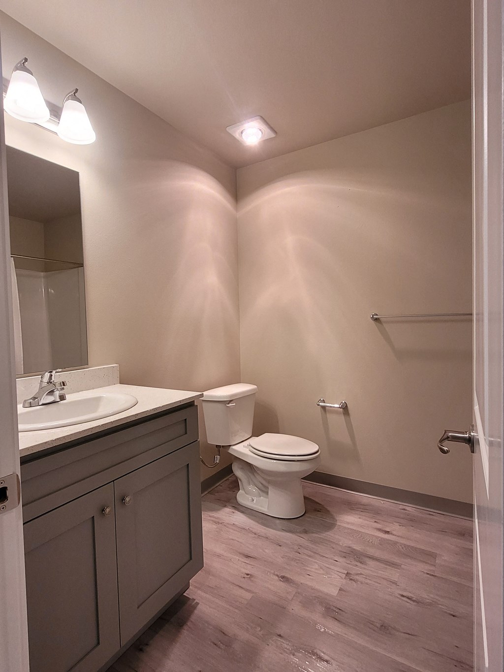 a bathroom with a toilet and a sink and a mirror