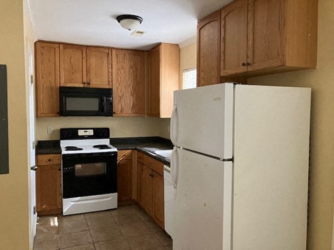 a kitchen with a refrigerator and a stove