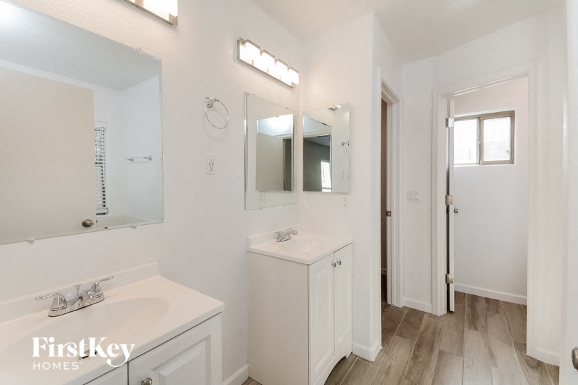 a white bathroom with a sink and a mirror
