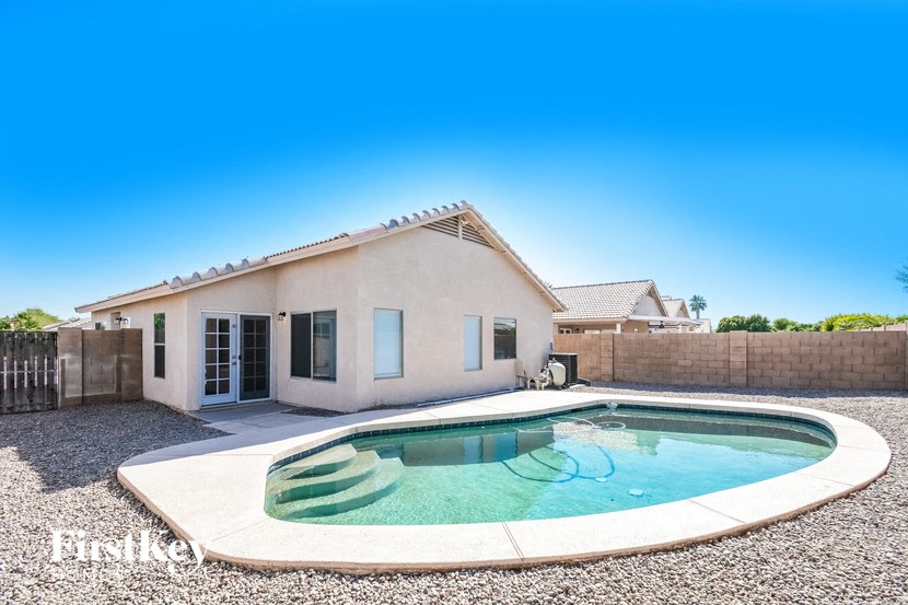 a pool and a house with a pool in front of it