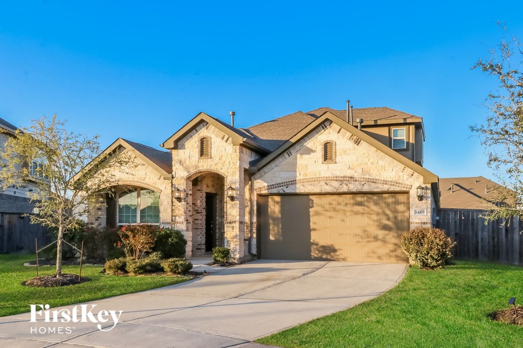 a house with a driveway and a garage door