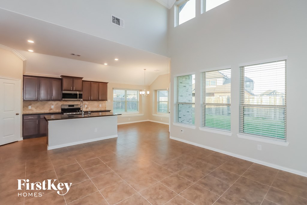 an open kitchen and living room with a large window