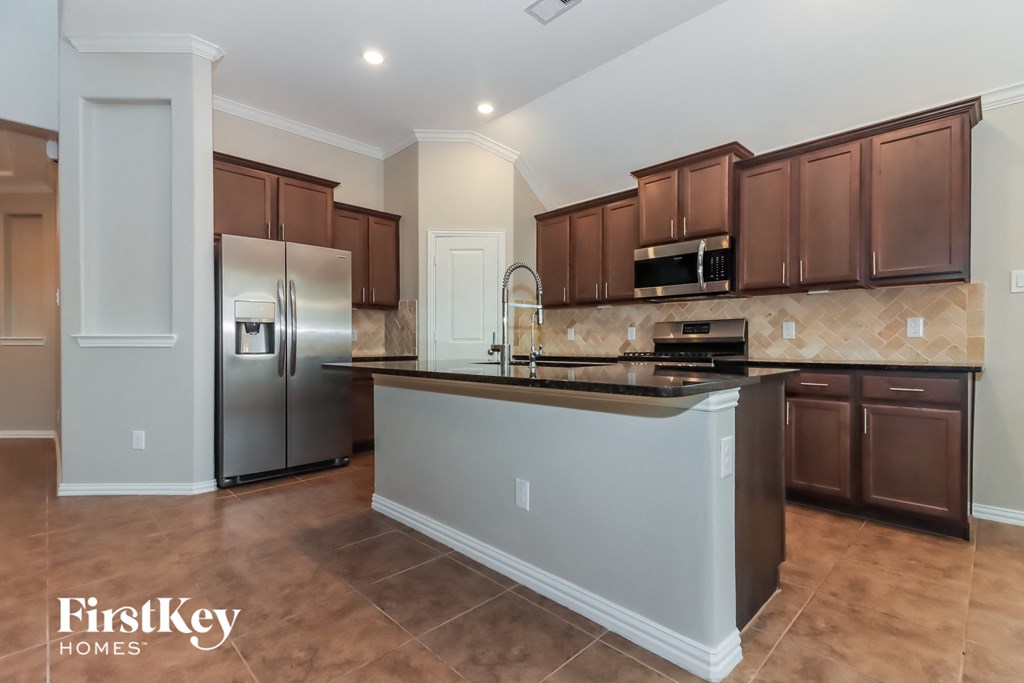 a kitchen with stainless steel appliances and a large island