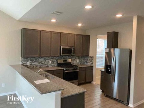 a kitchen with stainless steel appliances and granite counter tops
