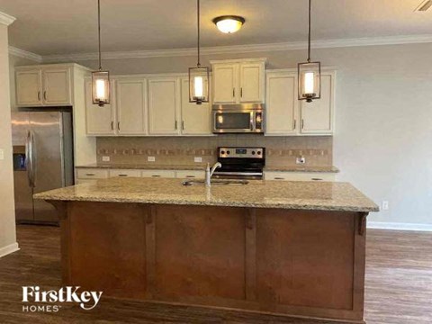 a kitchen with white cabinets and a counter top