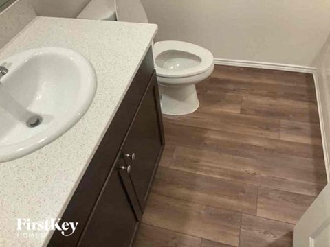 A bathroom with a toilet and a sink.