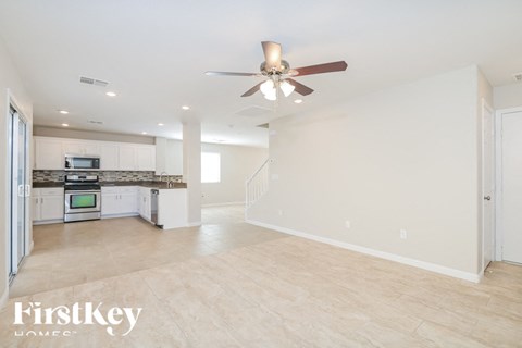 A spacious kitchen with a fan on the ceiling.