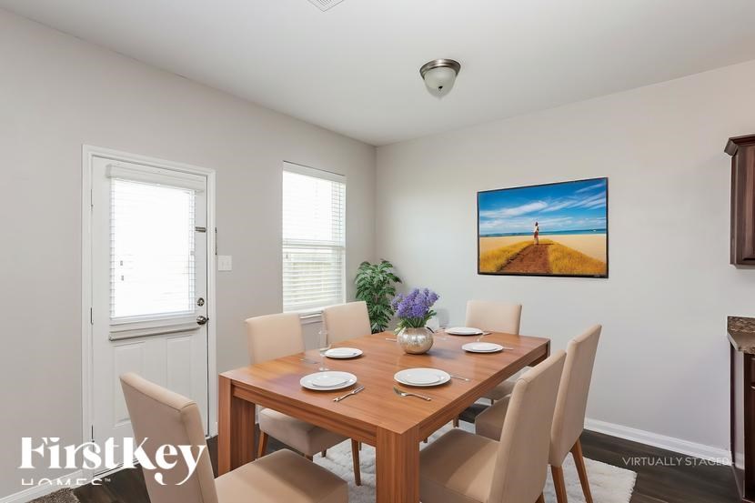 A dining room with a wooden table set for six.