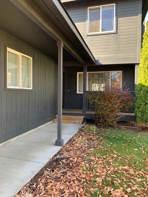 a front porch of a house with a sidewalk