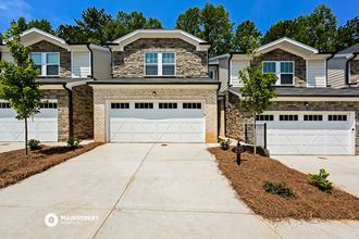 a house with two garage doors in front of it
