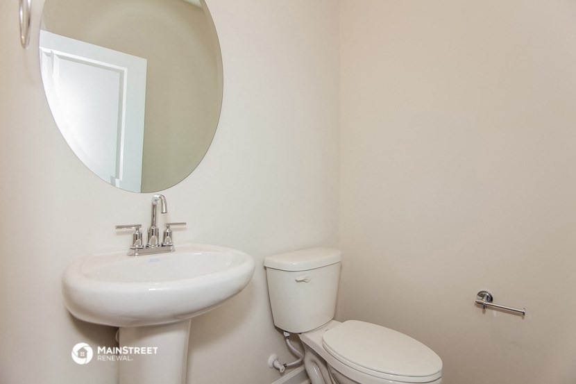 a bathroom with a sink and a toilet and a mirror